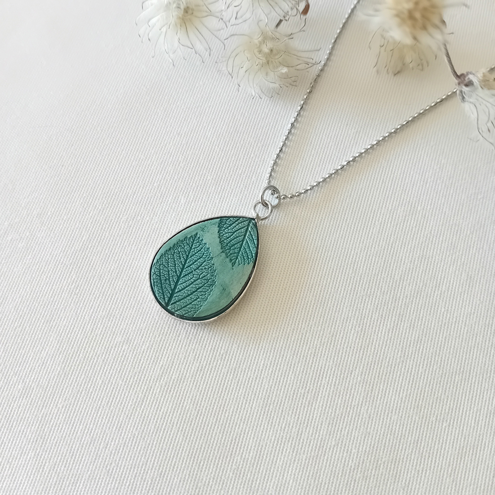 collier a planter par modibulle, en forme de goutte et de couleur vert canard, contenant des graines de tomates noires de crimee